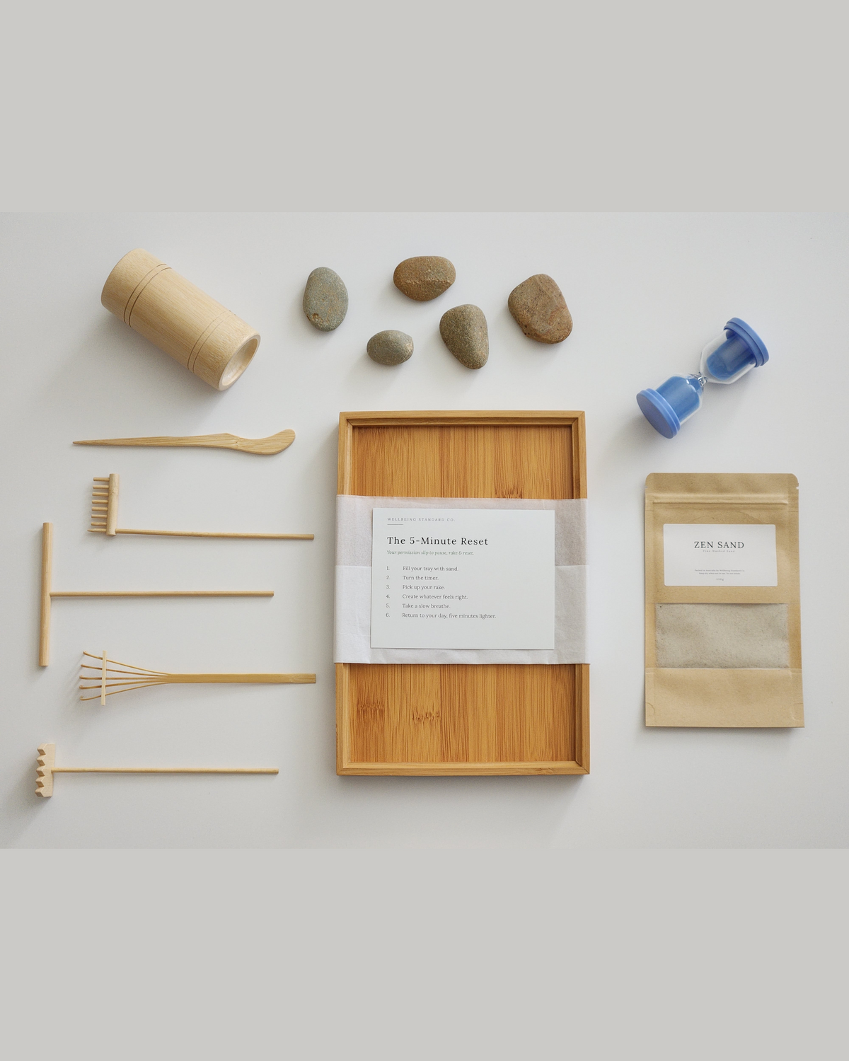The Resetter kit: wooden sand tray, rake, glass timer and natural stones
